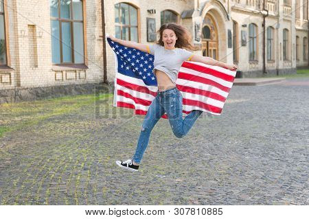 Being Free And Live Life Fully. Happy Girl Jumping Free With American Flag Outdoor. Sensual Woman Ce