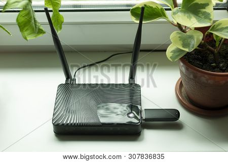 Insert A Mobile Usb Modem Into The Internet Router On The Window Sill By The Window