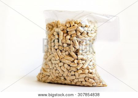 Wood Pellets In Plastic Bag On White Background. Feline Fresh Natural Pine Cat Litter In Transparent