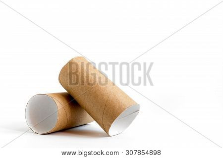 Close-up Of Empty Toilet Rolls. Two Cardboard Paper Tubes On White Background. Copy Space