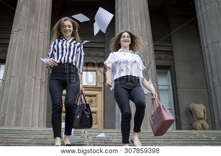 Two Young Happy Students Passed Exams And Leave Home For School, They Run Up The Stairs And Throw Aw