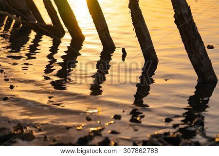 Sunset On The Kuyalnik Liman. Odessa. Ukraine. Old Logs Are Visible From The Water - The Remains Of 