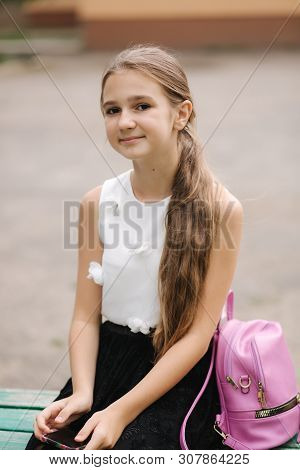 Young Girl Use Phone During School Break. Girl Play Online Games