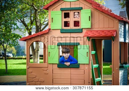 Two Little Boys Playing Together And Having Fun. Lifestyle Family Moment Of Siblings On Playground.