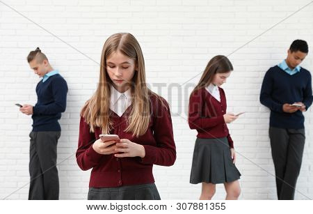 Teenagers Using Mobile Phones At School. Concept Of Internet Addiction And Loneliness