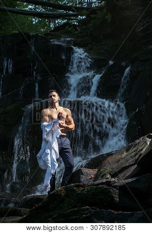 Muscular Man Going To Swim In Waterfall Water. Flow Of Dollars. Profit Business Concept. Businessman