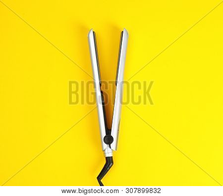 Modern Hair Iron For Straightening On Color Background, Top View