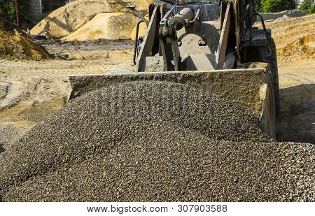 Tractor Collects Scoop With  Gravel. Excavator Extracts Sand And Gravel For  Concrete Mix.