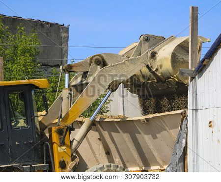 Tractor Collects Scoop With  Gravel. Excavator Extracts Sand And Gravel For  Concrete Mix.