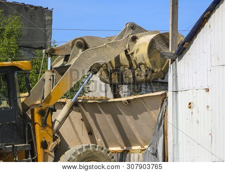 Tractor Collects Scoop With  Gravel. Excavator Extracts Sand And Gravel For  Concrete Mix.
