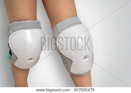Pair Of Knee Pads Wearing On Legs Of Child