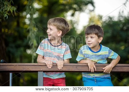Two Kids On The Hiking, Stand And Look At The Horizon Surrounded By Warm Sunny Colors. Concept Of Fr