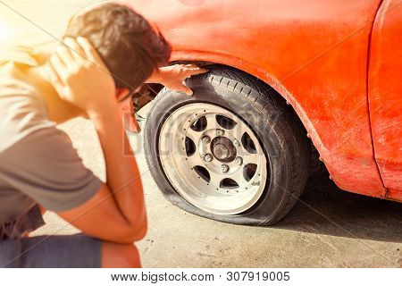 A Man Headache When Car Breakdown And Wheel Flat Tire In Parking