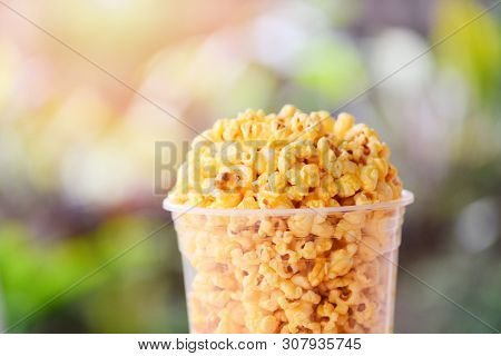 Popcorn In Cup And Nature Green And Sunlight Backgroubd / Sweet Butter Popcorn Salt