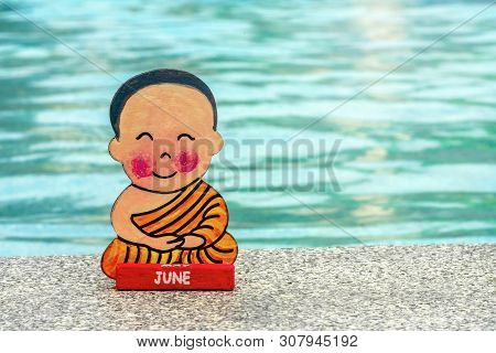 Buddhist Boy On Vacation Sitting In Lotus Position Happy Summer At The Edge Of The Pool. Close Up, C