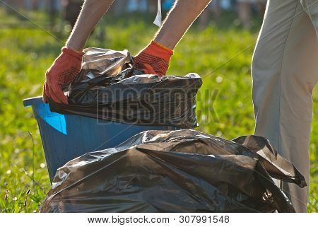 Blue Litter On Green Grass. Garbage In The Nature After The Concert.
