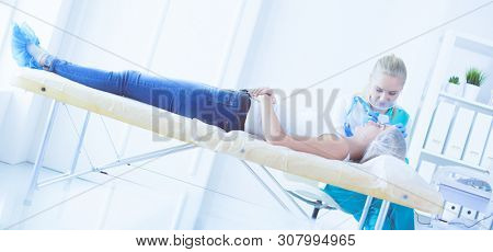 Portrait of female standing near open fridge full of healthy food, vegetables and fruits. Portrait of female