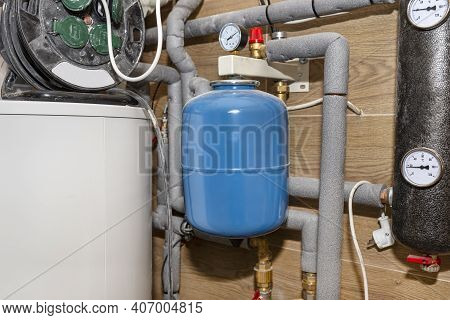 Expansion Vessel Protecting Against Pressure In A Modern Boiler Room Lined With Ceramic Tiles For Na