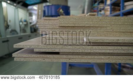 Fiberboard At A Furniture Factory. Boards At The Factory Close-up. Fragment Of A Wooden Panel Made O