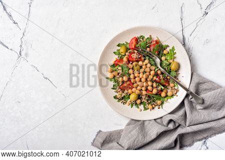 Healthy Vegetarian Salad With Cooked Chickpeas, Chia Seeds, Fresh Arugula, Cherry Tomatoes And Olive