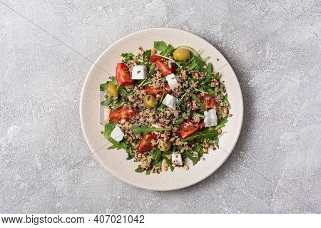 Healthy Vegetarian Salad With Cooked Chia Seeds, Fresh Arugula, Cherry Tomatoes, Soft Cheese And Oli