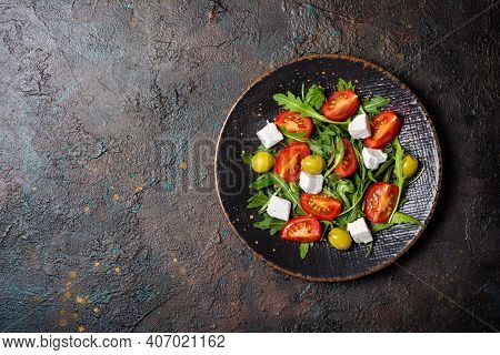 Healthy Vegetarian Salad With Fresh Arugula, Cherry Tomatoes, Soft Cheese And Olives