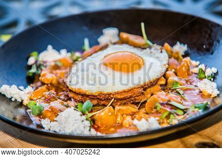 Chicken sote with pancakes and egg. The food in the restaurant. Food styling and restaurant meal serving.