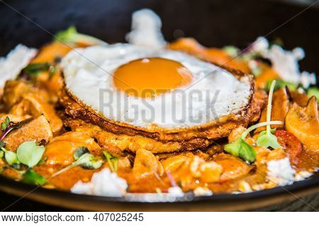 Chicken sote with pancakes and egg. The food in the restaurant. Food styling and restaurant meal serving.