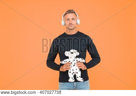 Childish And Infantile. Childish Adult Hold Toy Dog Yellow Background. Imaginative Friend. Pretend P