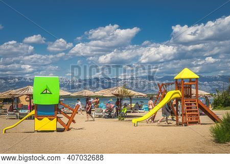 Nin, Croatia, July 2019 Kids Playground On Zdrijac Beach Between Nin Bay And Adriatic Sea With Mount