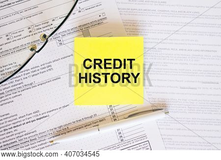 Yellow Sticker With Text Credit History On Financial Docs. Notepad, Eyeglasses And White Pen