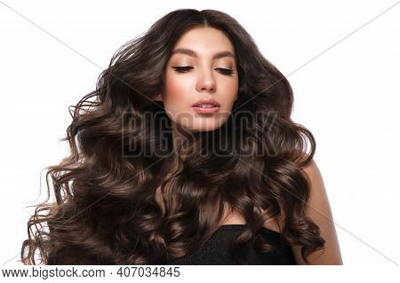 Beautiful Brown-haired Girl With A Perfectly Curls Hair, And Classic Make-up. Beauty Face And Hair.