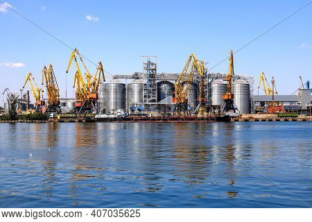 Big Port At Sea, Harbor, Pier By The Water. Yellow Harbor Cranes, A Barge At The Odessa Seaport Amon