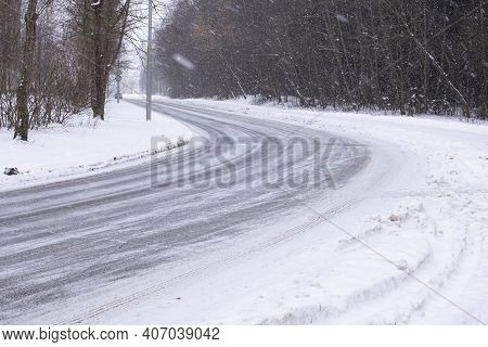 Snow And Car Wheel Marks On The Road Close Up