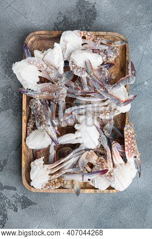 Frozen Raw  Blue Swimming Crab Parts Set, On Wooden Tray, On Gray Background, Top View Flat Lay