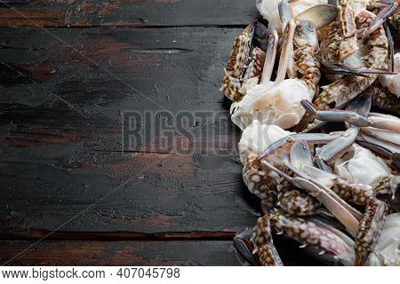 Fresh Raw Blue Swimming Crab Ocean Gourme Parts Set, On Dark Wooden Background, Top View Flat Lay , 