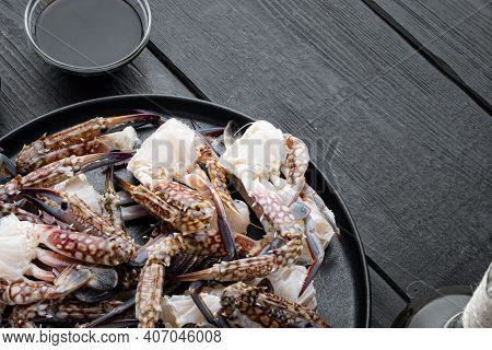 Fresh Raw Blue Swimming Crab Ocean Gourme Parts Set, On Plate, On Black Wooden Table Background , Wi