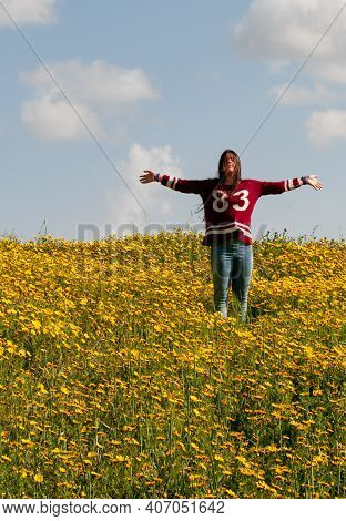 Happy Girl And A Field With Yellow Flowers In Spring. Spingtime Cyprus