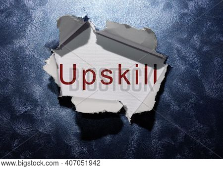 Upskill Text Revealed In Ripped Blue Paper Background .