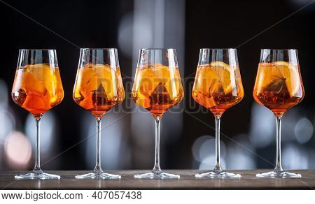 Summer Sekt Drink Aperol Spritz Served In Wine Glasses With Aperol, Prosecco, Soda And A Slice Of Or