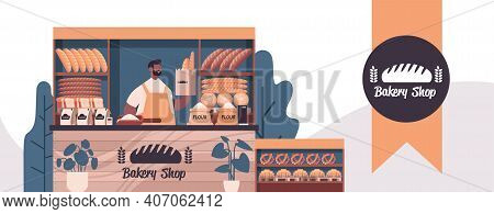 Male Baker Holding Bag With Baguettes Man In Uniform Selling Fresh Bakery Products In Baking Shop Po