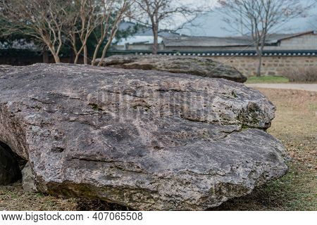 Closeup Of Large Boulder Used As Capstone On Dolmen Tomb With Slightly Blurred In Background.