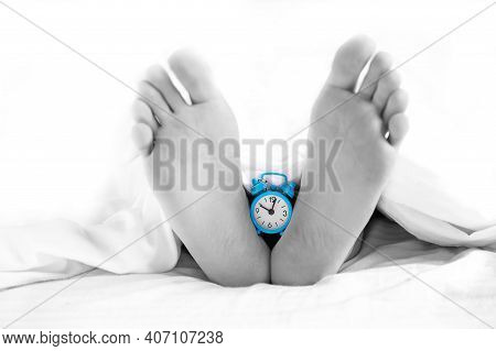 . The Legs Of The Deceased With A Clock Hanging On Them. Time Of Death. Morgue. Human Life Brevity C