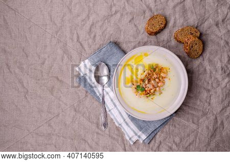 Vegetable Cream Soup With Beans And Spicy Oil In A Bowl On A Textile Background. Selective Focus.