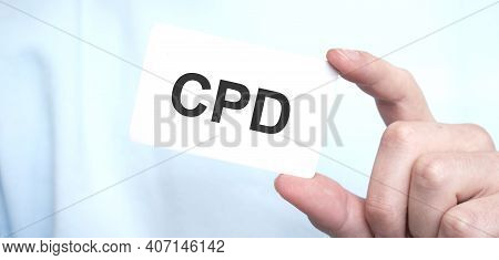 Man In Blue Sweatshirt Holding A Card With Text Cpd, Business Concept