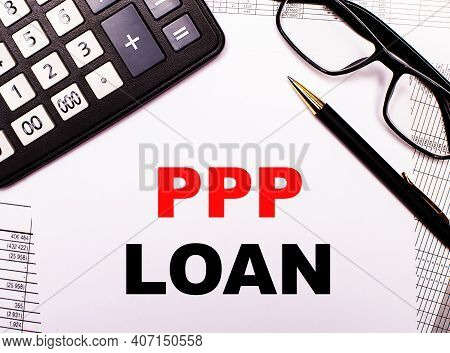 On The Reports There Is A Calculator, Glasses, A Pen And A Notebook With The Inscription Ppp Paychec