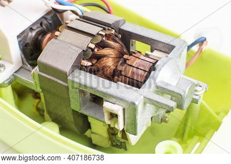 Broken Electric Motor In A Household Appliance Hand Mixer. Malfunction Of The Rotor And Stator Of El