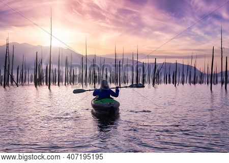 Adventurous Girl Kayaking On An Infatable Kayak In A Beautiful Lake. Colorful Peaceful Sunrise Art R
