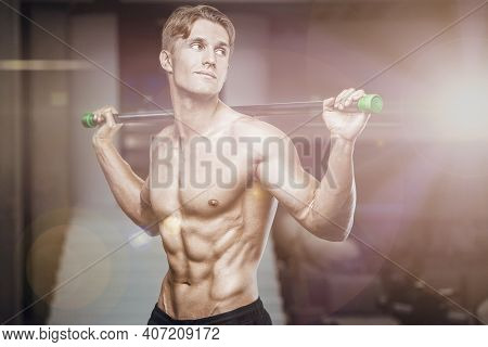 Fitness Man At Workout In Gym With Bodybar Stretching Muscles. Workout Fitness And Bodybuilding Heal