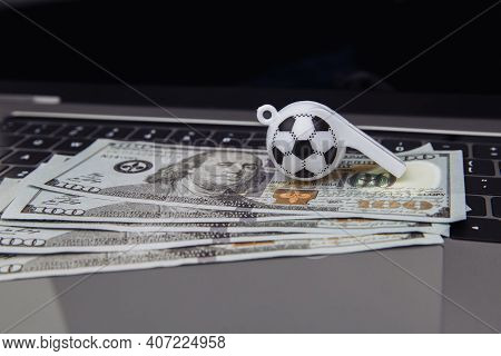 Soccer Whistle And Dollar Banknotes On Laptop. Betting On Sport Online Concept